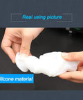 White rubber scalable dust cover for electric hammer drill, showing flexible silicone material, held in hands.