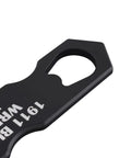 Close-up of black multifunction 1911 wrench kit aluminum tool for cleaning and disassembly, ergonomic grip visible.