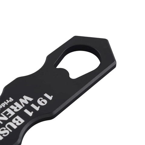 Close-up of black multifunction 1911 wrench kit aluminum tool for cleaning and disassembly, ergonomic grip visible.