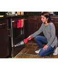 Woman using Compact Lithium Hand Vacuum Kit With 2Ah Battery For Cars And Home Multi Surface Cleaning Lightweight Cordless Design