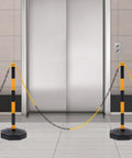 Hardcore 6 Pack Safety Bollards With Fillable Base And Interlocking Chains High Visibility Yellow Black Plastic Traffic Posts For Driveways Lots And Warehouse Zones Built Tough Us Stock set up near an elevator with linked chains.
