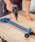 Person using Shelf Pin Drilling Jig For Cabinets And Woodworking With 1/4 Inch And 5mm Self Centering Bits on wooden panel