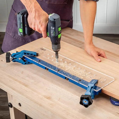 Person using Shelf Pin Drilling Jig For Cabinets And Woodworking With 1/4 Inch And 5mm Self Centering Bits on wooden panel