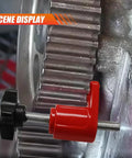 Automotive camshaft locking tool with red body and black knob, side view mounted on timing gear