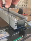 Adjusting Heavy Duty Digital Table Saw Fence System Built Tough With Industrial Steel And Aluminum on a workbench.