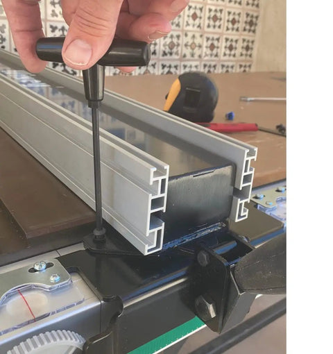Adjusting Heavy Duty Digital Table Saw Fence System Built Tough With Industrial Steel And Aluminum on a workbench.