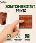 Hand touching a scratch-resistant military battlefield base magnetic tile with brick print, showing durability and color.