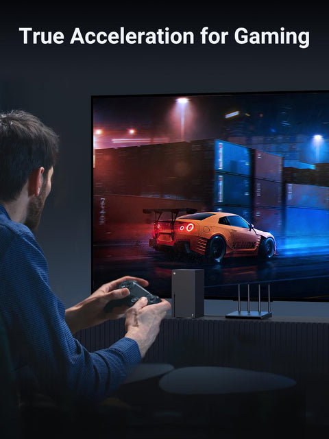 Person playing a racing video game on a large screen, emphasizing true acceleration for gaming with a racing car displayed.