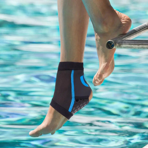 Person wearing AquaFlex Pro Ankle Brace Compression Sleeve for Water Sports and Recovery by poolside, displaying sleek design.