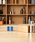 Two Ten Piece Blue Aluminum Motor Shaft Coupling Connectors 6mm on a wooden surface for 3D Printers And CNC Machines.