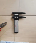 2pcs ABS Wheel Bolt Spacing Tool for Wheel Hub Precision Measurement on wood surface with pliers, showing precise measuring details.