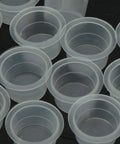 Close-up of Large Tattoo Ink Cups 500 Pack Plastic Pigment Cups Size 15 Disposable Microblading Cups for supplies bulk set