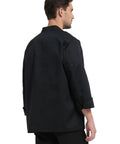 Back view of a man wearing a Straight Fire Kickass Chef Coat Black Long Sleeve Kitchen Workwear, rugged and breathable.