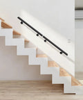 Heavy Duty Wall Mounted Stair Handrail Built From Premium Stainless Steel Providing A Rock Solid Grip And A Slick Black Finish For Dependable Daily Use And Home Safety installed on modern staircase.