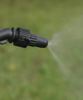 Farm Grade Adjustable Spray Gun With 50 Inch Reach, 18 Orifice, 150 Psi Max, spraying mist in a garden setting.