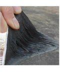 Close-up of Heavy Duty Torch On Asphalt Roof Sealant Roll being applied to a surface, showcasing the thick rubberized material.