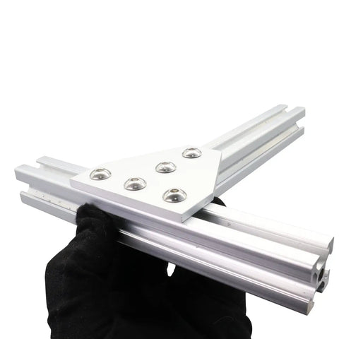 Hand holding 10 Series 1010 Aluminum Extrusion Corner Bracket Kit showing 1x1 corner T bracket with screws for frame assembly
