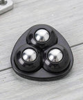 Mini Caster Wheels 12pcs 360 Degree Swivel Adhesive for Furniture, close-up of three black plastic ball casters on a light wood surface.