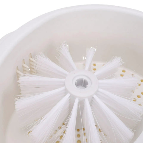 Interior view of Straight Up Game Changer Electric Salad Spinner With Rapid Drain Tech, featuring cleaning brush and draining holes.