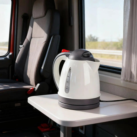 Heavy Duty 24V Electric Kettle For Trucks Built Like A Tank With Auto Shut Off 1 Liter Portable Water Heater on a table in a truck cabin.