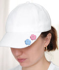 Woman wearing white cap with blue and pink flower-shaped Magnetic Golf Ball Marker With Hat Clip Set Two Piece Flower Shape Markers