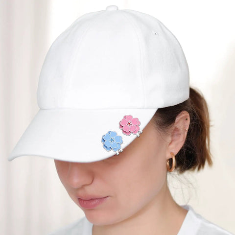 Woman wearing white cap with blue and pink flower-shaped Magnetic Golf Ball Marker With Hat Clip Set Two Piece Flower Shape Markers