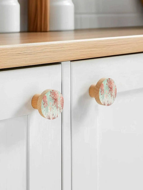 Two Pack Solid Beech Wood Cabinet Knobs 1.4 Inch Round Wooden Drawer Pulls With A Slick Green Forest Finish on white cupboards.