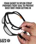 Pro Full-Frame Safety Glasses With Removable Gasket in hand, showing foam gasket and nylon strap for a tight seal.