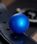 Blue Rubber Ball Watch Case Back Opener For Battery Replacement shown on leather surface