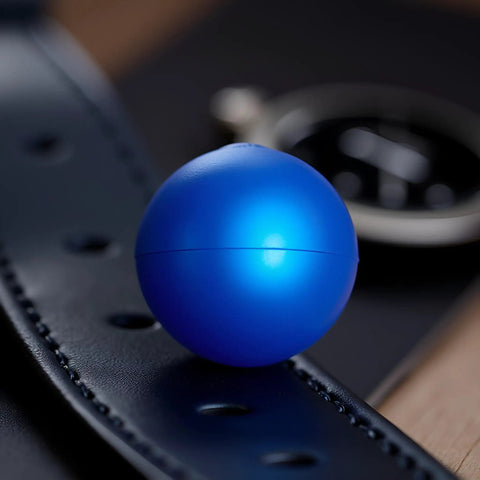 Blue Rubber Ball Watch Case Back Opener For Battery Replacement shown on leather surface