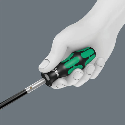 Hand holding Kraftform 392 Hexagon Flexible Shaft Bit Holder Screwdriver with Quick Release Chuck, green-black handle, close up