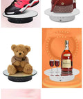 JAYEGT Motorized Rotating Display Stand, 7.87 Inch 360 Degree Electric Turntable showcasing various products like shoes, bags, and decor.