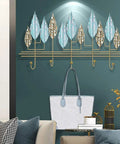 Rock Solid Wall Mounted Coat Rack With Heavy Duty Iron Hooks For Entryway And Mudroom Storage, featuring a stylish leaf design and a bag hanging.