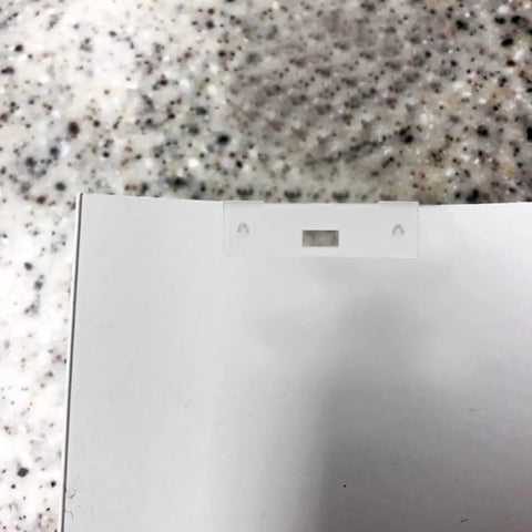 Close-up of a white metal vertical blind repair tab, showing a clip for attaching to blinds, from the 10 Pc Vertical Blind Repair Tabs Heavy Duty Metal Vane Savers Universal Fit Stop The Madness Of Broken Blinds Rust Proof Fixer For Dog Nips Wind Damage Sturdy.