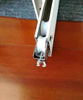 Close-up of Slick Glide Double Wheel Sliding Door Track Rollers With 27Point5Mm Nylon Wheels, showing white wheels in stainless steel casing.