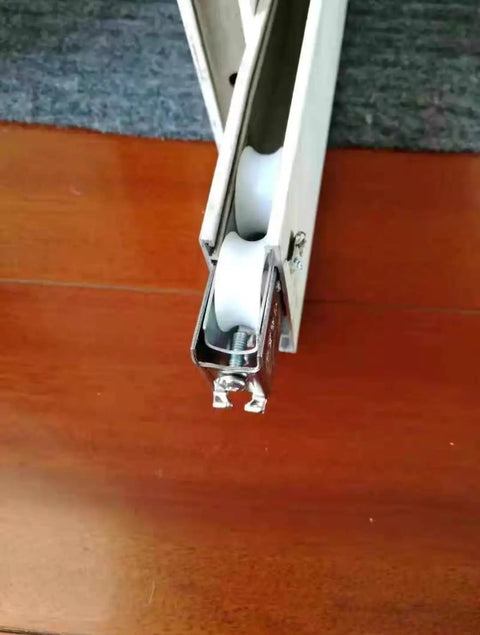 Close-up of Slick Glide Double Wheel Sliding Door Track Rollers With 27Point5Mm Nylon Wheels, showing white wheels in stainless steel casing.