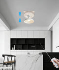 Heavy Duty Electric Chandelier Hoist With 220 Lb Load Capacity And 26 Ft Lift Stroke For Ceiling Fixtures in a modern kitchen, demonstrating remote operation.