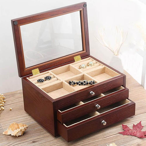 Wooden jewelry box with open drawers on table, showing compartments with visible 1 inch brass butt hinges.