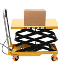 Hydraulic lift table cart, yellow with scissor mechanism, cardboard box on top; four orange locking wheels