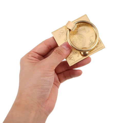 Hand holding a Vintage Brass Cabinet Pull Handle Set with Drop Ring Knobs, 6cm square edge, pure brass Chinese style hardware.