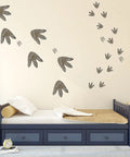 Bedroom with dinosaur footprint wall stickers above bed; 64 Piece Dinosaur Footprint Floor Decals Peel And Stick Dinosaurs Wall Tracks Stickers For Baby Nursery Bedroom Home Decor Removable Vinyl Footprints Great For DIY Walls And Floors