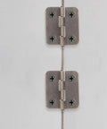Close-up of Miniature Iron Chest Hinges With Screws for Antique Jewelry Boxes and Small Wooden Chests, Retro Cabinet Hardware