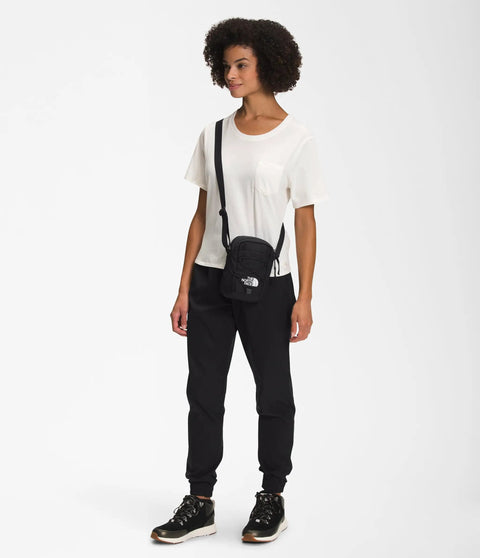 Person wearing Jester Crossbody Bag Dope Everyday Carry Sling With Water-Repellent Fabric, black with adjustable strap