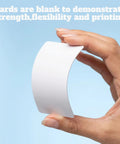 Top Shelf 1000 Pack Blank CR80 PVC ID Cards, Thick 30 Mil White Plastic Credit Card Size Swipes held in hand to show flexibility.