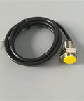 Amazon NPN M18 proximity sensor with yellow sensing face, metal threaded body and attached black cable