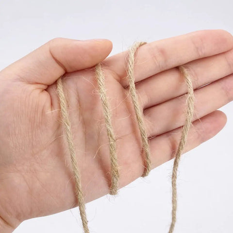 Close-up of hand holding 1000 Ft 3Mm Natural Jute Twine Rope Heavy Duty Garden String for bundling crafts and gift wrapping