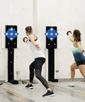 Two women practicing fencing on Five Target Fencing Practice Pad For Foil And Epee Wall Mounted Striking Target Gear.