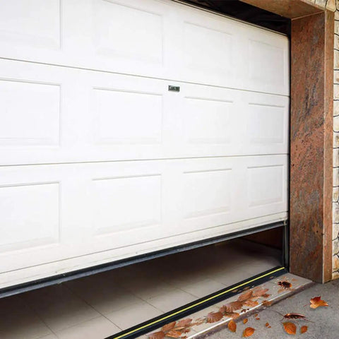 White garage door with installed Garage Door Threshold Seal Weather Stripping Bottom Rubber 20 Feet Long 3.15 Inch Wide.