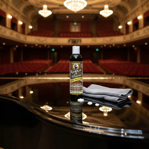 Top Shelf Wood Polish And Gloss Restorer to Wipe Away Scratches Haze and Dust on a grand piano with a cleaning cloth.