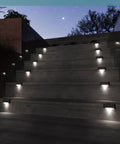 Heavy Duty Solar Deck Lights Outdoor 16 Pack Waterproof LED Step Lights For Stairs Fence Steps And Patio Railings, illuminating staircase at night.
